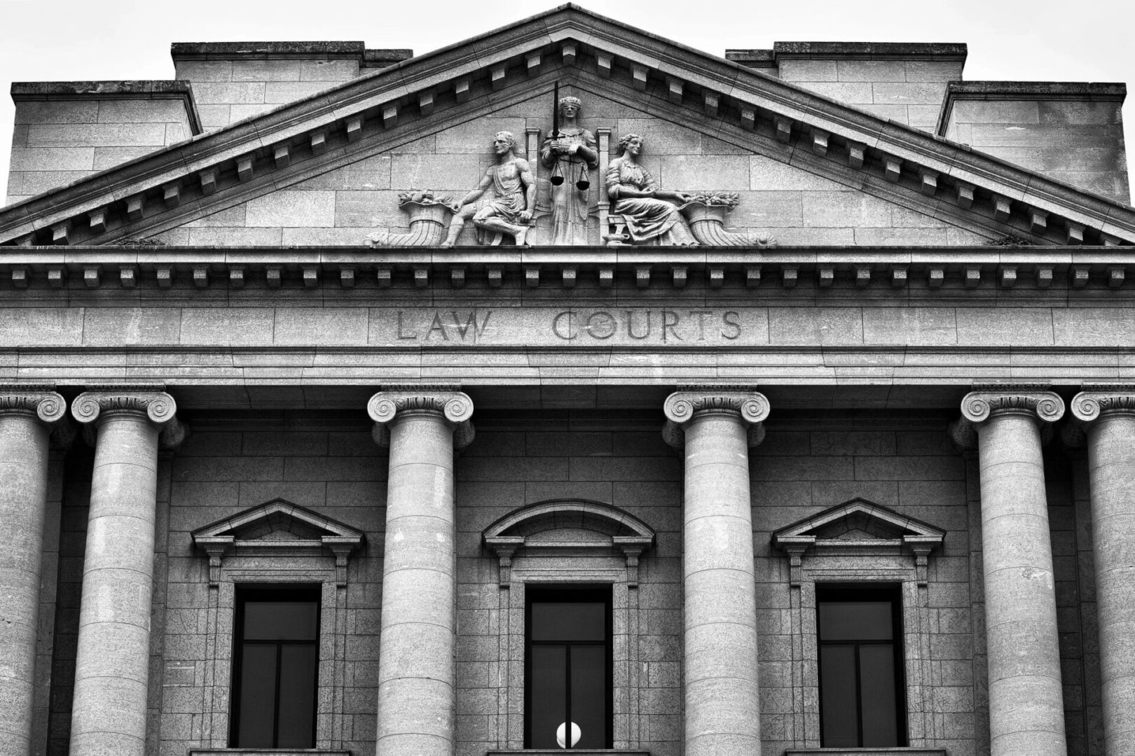 A black and white photo of the front of a building.